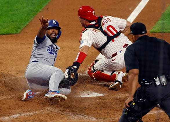 Los Angeles Dodgers Teoscar Hernandez (37) slides into home to score past the tag of Philadelphia Phillies catcher J.T. Realmuto (10) in the seventh inning during game two of the MLB, Baseball Herren, USA National League Division Series at Citizens Bank Park in Philadelphia on Monday, October 6, 2025. PHI20251006816 LAURENCExKESTERSON