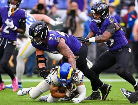 Los Angeles Rams wide receiver Jordan Whittington (88) recovers a Rams fumble under pressure from Baltimore Ravens defensive lineman Brent Urban (97) during the fourth quarter at M&T Bank Stadium in Baltimore, Maryland, on Sunday, October 12, 2025. BAL20251012135 DAVIDxTULIS