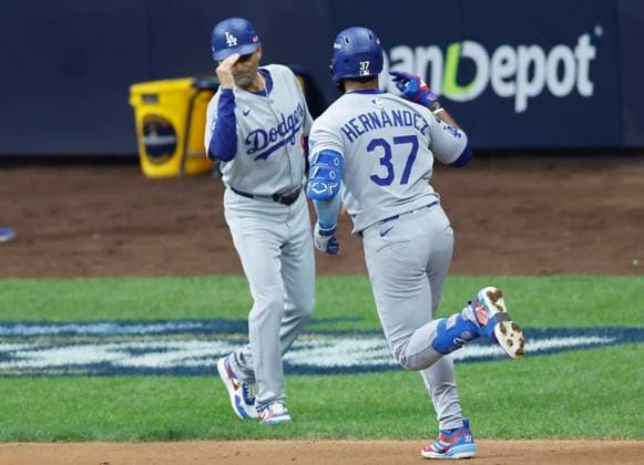 Los Angeles Dodgers Teoscar Hernandez (37) is congratulated by third base coach Dino Ebel after hitting a solo home run in the second inning against the Milwaukee Brewers during game two of the MLB, Baseball Herren, USA National League Championship Series at American Family Field in Milwaukee, Wisconsin, on Tuesday, October 14, 2025. MIL20251014708 TANNENxMAURY