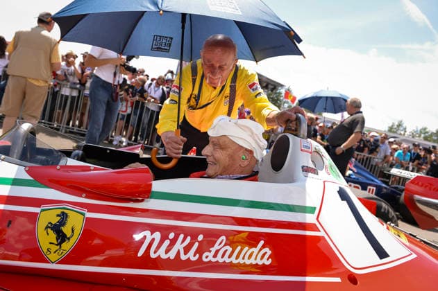 Formula 1 GP Austria the Former Austrian Formula 1 Racers and World Champion Niki Lauda 1949 2019 sits at 22 06 2014 during the Legends Parade before the grand Prize from Austria 2014 on the Red Bull Ring in Spielberg Styria at Tax its Ferrari 312 T2 be Chief mechanic out the Time, the Italians Ermanno Cuoghi, holds him the Screen this is the famous Model, with the Lauda 1976 and 1977 for Ferrari drove and with the he 1977 his second World Championship title won it is a the best known and successful Formula 1 Dare the 70 Years