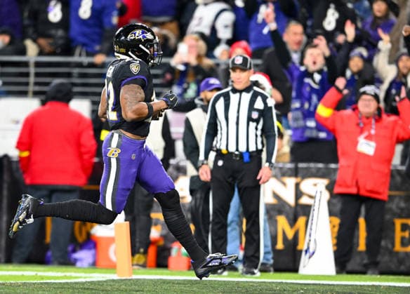 Baltimore Ravens running back Derrick Henry (22) rushes for a 21-yard touchdown run against the New England Patriots during the first quarter at M&T Bank Stadium in Baltimore, Maryland, on Sunday, December 21, 2025. BAL20251221117 DAVIDxTULIS