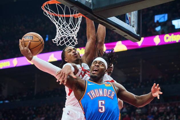 February 24, 2026, Toronto, On, Canada: Oklahoma City Thunder s Luguentz Dort (5) is stopped at the net by Toronto Raptors Collin Murray-Boyles (12) during first half NBA, Basketball Herren, USA basketball action in Toronto, on Tuesday, Feb. 24, 2026. Canada News - February 24, 2026 - ZUMAc35_ 20260224_zaf_c35_096 Copyright: xSammyxKoganx