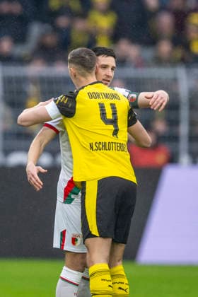 14 03 2026 Football Borussia Dortmund FC Augsburg, Matchday 26 at Signal Iduna Park The brothers Keven Schlotterbeck FC Augsburg l and Nico Schlotterbeck Borussia Dortmund embrace IMPORTANT NOTICE According to the regulations of the DFL and the DFB, it is prohibited to use or have used photographs taken in the stadium and or of the match in the form of sequential images and or video-like photo series Copyright: xDavidxInderliedx