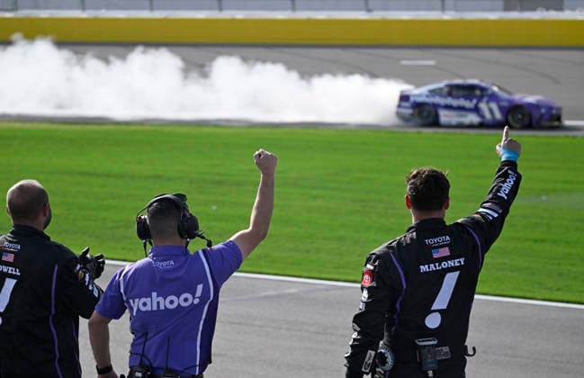 LAS VEGAS, NV - MARCH 15: Denny Hamlin ( 11 Joe Gibbs Racing Yahoo! Toyota) celebrates with a burnout down the front straight as his crew reacts after winning the NASCAR, Motorsport, USA Cup Series Pennzoil 400 on March 15, 2026, at Las Vegas Motor Speedway in Las Vegas, NV. (Photo by Will Lester Icon Sportswire) AUTO: MAR 15 NASCAR Cup Series Pennzoil 400 EDITORIAL USE ONLY Icon24031515477