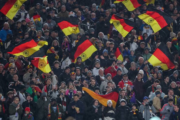 30 03 2026, Football, International match, Germany Ghana, MHP Arena Stuttgart , Season 2025 2026 Football fans Fans in the stands Cheering flags Flag Germany flags Germany fans Football fans DFB regulations prohibit any use of photographs as image sequences and or quasi video Baden Württemberg Germany