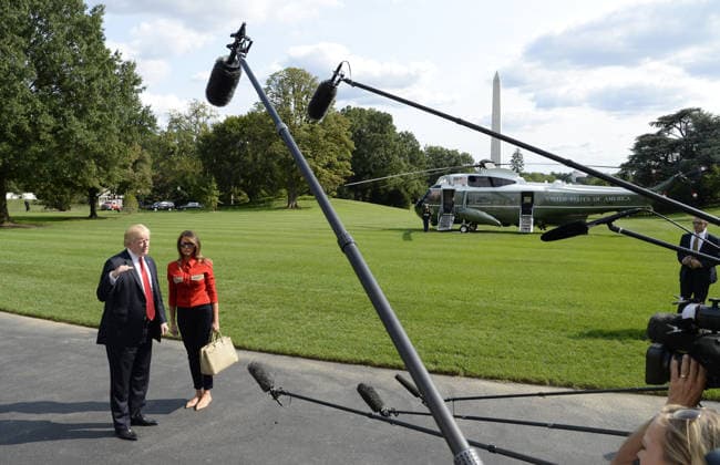 September 10, 2017 - Washington, District of Columbia, United States of America - United States President Donald J. Trump speaks to members of the media about Hurricane Irma as first lady Melania Trump looks on upon their arrival on the South Lawn of the White House in Washington, DC, September 10, 2017, after spending the weekend at Camp David, the Presidential retreat near Thurmont, Maryland. .Credit: Olivier Douliery Pool via CNP Copyright: xOlivierxDoulieryx