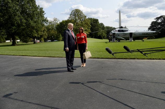 September 10, 2017 - Washington, District of Columbia, United States of America - United States President Donald J. Trump speaks to members of the media about Hurricane Irma as first lady Melania Trump looks on upon their arrival on the South Lawn of the White House in Washington, DC, September 10, 2017, after spending the weekend at Camp David, the Presidential retreat near Thurmont, Maryland. .Credit: Olivier Douliery Pool via CNP Copyright: xOlivierxDoulieryx