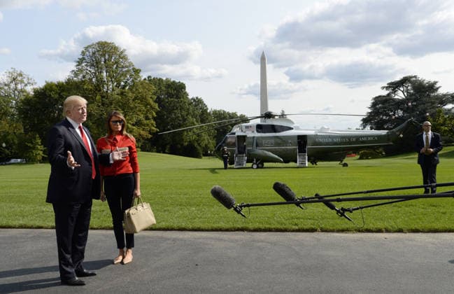 September 10, 2017 - Washington, District of Columbia, United States of America - United States President Donald J. Trump speaks to members of the media about Hurricane Irma as first lady Melania Trump looks on upon their arrival on the South Lawn of the White House in Washington, DC, September 10, 2017, after spending the weekend at Camp David, the Presidential retreat near Thurmont, Maryland. .Credit: Olivier Douliery Pool via CNP Copyright: xOlivierxDoulieryx