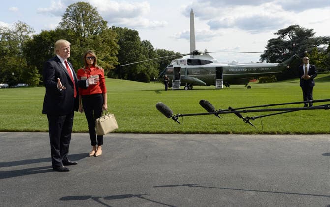 September 10, 2017 - Washington, District of Columbia, United States of America - United States President Donald J. Trump speaks to members of the media about Hurricane Irma as first lady Melania Trump looks on upon their arrival on the South Lawn of the White House in Washington, DC, September 10, 2017, after spending the weekend at Camp David, the Presidential retreat near Thurmont, Maryland. .Credit: Olivier Douliery Pool via CNP Copyright: xOlivierxDoulieryx