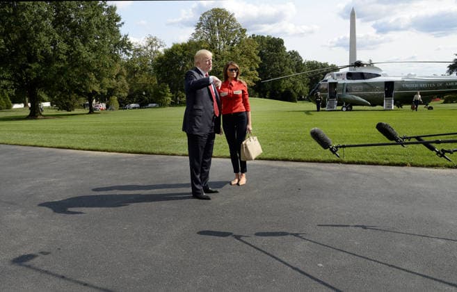 September 10, 2017 - Washington, District of Columbia, United States of America - United States President Donald J. Trump speaks to members of the media about Hurricane Irma as first lady Melania Trump looks on upon their arrival on the South Lawn of the White House in Washington, DC, September 10, 2017, after spending the weekend at Camp David, the Presidential retreat near Thurmont, Maryland. .Credit: Olivier Douliery Pool via CNP Copyright: xOlivierxDoulieryx