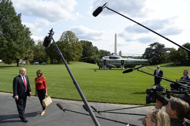 September 10, 2017 - Washington, District of Columbia, United States of America - United States President Donald J. Trump speaks to members of the media about Hurricane Irma as first lady Melania Trump looks on upon their arrival on the South Lawn of the White House in Washington, DC, September 10, 2017, after spending the weekend at Camp David, the Presidential retreat near Thurmont, Maryland. .Credit: Olivier Douliery Pool via CNP Copyright: xOlivierxDoulieryx