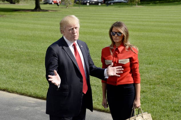 September 10, 2017 - Washington, District of Columbia, United States of America - United States President Donald J. Trump speaks to members of the media about Hurricane Irma as first lady Melania Trump looks on upon their arrival on the South Lawn of the White House in Washington, DC, September 10, 2017, after spending the weekend at Camp David, the Presidential retreat near Thurmont, Maryland. .Credit: Olivier Douliery Pool via CNP Copyright: xOlivierxDoulieryx