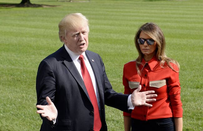 September 10, 2017 - Washington, District of Columbia, United States of America - United States President Donald J. Trump speaks to members of the media about Hurricane Irma as first lady Melania Trump looks on upon their arrival on the South Lawn of the White House in Washington, DC, September 10, 2017, after spending the weekend at Camp David, the Presidential retreat near Thurmont, Maryland. .Credit: Olivier Douliery Pool via CNP Copyright: xOlivierxDoulieryx