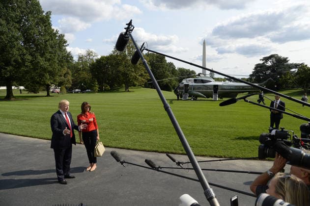 September 10, 2017 - Washington, District of Columbia, United States of America - United States President Donald J. Trump speaks to members of the media about Hurricane Irma as first lady Melania Trump looks on upon their arrival on the South Lawn of the White House in Washington, DC, September 10, 2017, after spending the weekend at Camp David, the Presidential retreat near Thurmont, Maryland. .Credit: Olivier Douliery Pool via CNP Copyright: xOlivierxDoulieryx