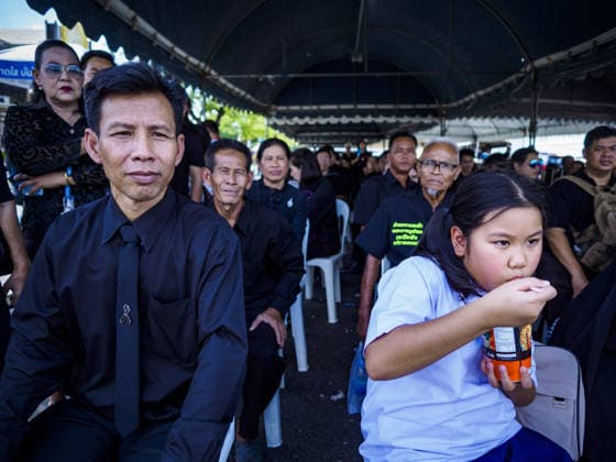 September 27, 2017 - Bangkok, Bangkok, Thailand - A school girl waiting to pay her respects to the funeral urn of the Late King eats a bowl of instant noodles while she waits in line to be admitted to the Grand Palace. Bhumibol Adulyadej, the Late King of Thailand, died on October 13, 2016. Thailand has been in a state of mourning since. He will be cremated on October 26, 2017. Thais have been going to the Grand Palace to pay respects to the revered King. The Thai government has announced that the palace will close to the public on October 4, 2017, to prepare for the Monarch s funeral. Since the announcement, tens of thousands of Thais have lined up at the palace every day to pay their final respects. Copyright: xSeanxEdisonx