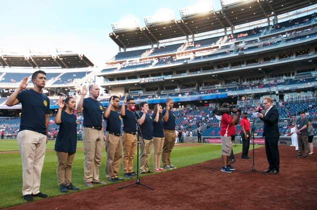 May 1, 2018 - Washington, District of Columbia, U.S. - Under Secretary of the Navy, the honorable THOMAS B. MODLY, right, administers the oath of enlistment to 10 Virginia-area recruits during the Washington Nationals Navy Night pregame ceremony. The Washington Nationals hosted 278 Sailors and spouses in a show of support to the U.S. Navy while simultaneously increasing public awareness of the Navy mission. Copyright: xUSxNavyx