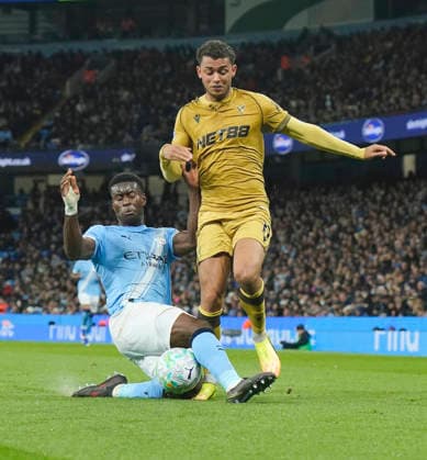 Manchester, England, 13th May 2026. Marc Guehi of Manchester City tackles Brennan Johnson of Crystal Palace during the Manchester City vs Crystal Palace Premier League match at the Etihad Stadium, Manchester. Picture credit should read: Andrew Yates Sportimage EDITORIAL USE ONLY. No use with unauthorised audio, video, data, fixture lists, club league logos or live services. Online in-match use limited to 120 images, no video emulation. No use in betting, games or single club league player publications. SPI_054_AY_Man_City_Palace SPI-4799-0052