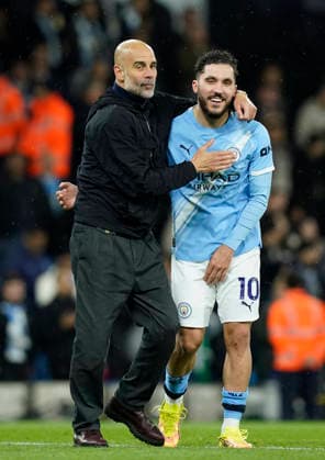 Manchester, England, 13th May 2026. Pep Guardiola coach of Manchester City celebrates with Rayan Cherki of Manchester City during the Manchester City vs Crystal Palace Premier League match at the Etihad Stadium, Manchester. Picture credit should read: Andrew Yates Sportimage EDITORIAL USE ONLY. No use with unauthorised audio, video, data, fixture lists, club league logos or live services. Online in-match use limited to 120 images, no video emulation. No use in betting, games or single club league player publications. SPI_069_AY_Man_City_Palace SPI-4799-0067