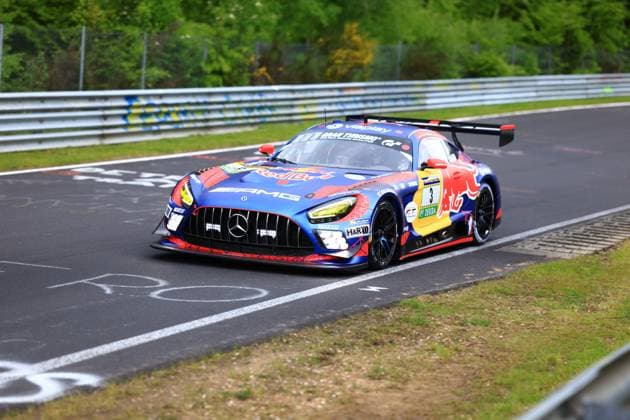 The Mercedes AMG GT3 with the starting number 3 of the Mercedes AMG Team Verstappen Racing drives through a curve on the Nordschleife at the Nürburgring The car Daniel Juncadella Jules Gounon Lucas Auer Max Verstappen Mercedes AMG Team Verstappen Racing wears a striking blue and red Red Bull livery with Spider Man motifs and sponsor logos from Viaplay, Gran Turismo, H R and DEKRA The car moves swiftly over the characteristic asphalt of the Nordschleife, flanked by green vegetation and the typical crash barriers Mercedes AMG GT3 3 from Mercedes AMG Team Verstappen Racing on the Nordschleife Copyright: xspeedshotx