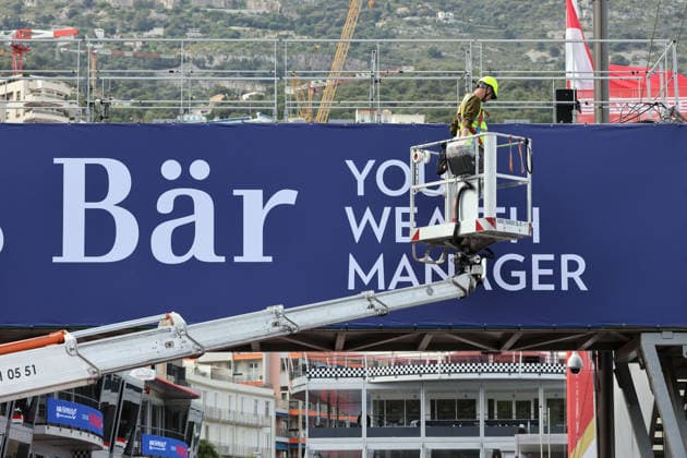 A trackside employee works on the Julius Baer advertising hoarding of a pedestrian bridge over the pit lane,, FIA Formula E World Championship Season 12, Monaco E Prix, MonteCarlo, MC, 14 05 2026,