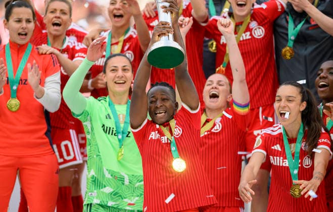 Award ceremony, cheering Bernadette AMANI M with the trophy DFB Cup Womens Final 2026, VfL Wolfsburg WOB FC Bayern Muenchen M 0 4, on 14 05 2026 in Cologne Germany DFB regulations prohibit any use of photographs as image sequences and or quasi video Â