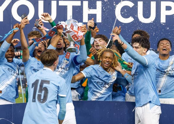 Manchester, England, 14th May 2026. Kaden Braithwaite of Manchester City lifts the FA Youth Cup after the team s victory following the Manchester City U18 vs Manchester United, ManU U18 FA Youth Cup Final match at the Academy Stadium, Manchester. Picture credit should read: Cody Froggatt Sportimage EDITORIAL USE ONLY. No use with unauthorised audio, video, data, fixture lists, club league logos or live services. Online in-match use limited to 120 images, no video emulation. No use in betting, games or single club league player publications. SPI_067_CF_MANCHESTER_CITY_U18_V_MANCHESTER_UNITED_U18 SPI-4801-0065