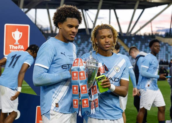 Manchester, England, 14th May 2026. Tyrone Samba and Floyd Samba of Manchester City celebrate with the FA Youth Cup trophy following the Manchester City U18 vs Manchester United, ManU U18 FA Youth Cup Final match at the Academy Stadium, Manchester. Picture credit should read: Cody Froggatt Sportimage EDITORIAL USE ONLY. No use with unauthorised audio, video, data, fixture lists, club league logos or live services. Online in-match use limited to 120 images, no video emulation. No use in betting, games or single club league player publications. SPI_074_CF_MANCHESTER_CITY_U18_V_MANCHESTER_UNITED_U18 SPI-4801-0072