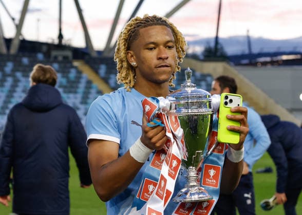 Manchester, England, 14th May 2026. Tyrone Samba of Manchester City celebrates with the FA Youth Cup trophy following the Manchester City U18 vs Manchester United, ManU U18 FA Youth Cup Final match at the Academy Stadium, Manchester. Picture credit should read: Cody Froggatt Sportimage EDITORIAL USE ONLY. No use with unauthorised audio, video, data, fixture lists, club league logos or live services. Online in-match use limited to 120 images, no video emulation. No use in betting, games or single club league player publications. SPI_076_CF_MANCHESTER_CITY_U18_V_MANCHESTER_UNITED_U18 SPI-4801-0074
