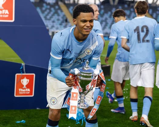 Manchester, England, 14th May 2026. Leke Drake of Manchester City celebrates with the FA Youth Cup trophy following the Manchester City U18 vs Manchester United, ManU U18 FA Youth Cup Final match at the Academy Stadium, Manchester. Picture credit should read: Cody Froggatt Sportimage EDITORIAL USE ONLY. No use with unauthorised audio, video, data, fixture lists, club league logos or live services. Online in-match use limited to 120 images, no video emulation. No use in betting, games or single club league player publications. SPI_081_CF_MANCHESTER_CITY_U18_V_MANCHESTER_UNITED_U18 SPI-4801-0079