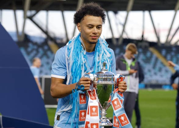 Manchester, England, 14th May 2026. Dante Headley of Manchester City celebrates with the FA Youth Cup trophy following the Manchester City U18 vs Manchester United, ManU U18 FA Youth Cup Final match at the Academy Stadium, Manchester. Picture credit should read: Cody Froggatt Sportimage EDITORIAL USE ONLY. No use with unauthorised audio, video, data, fixture lists, club league logos or live services. Online in-match use limited to 120 images, no video emulation. No use in betting, games or single club league player publications. SPI_082_CF_MANCHESTER_CITY_U18_V_MANCHESTER_UNITED_U18 SPI-4801-0080