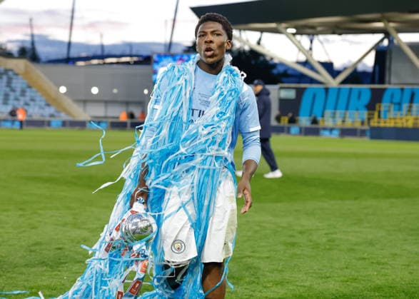 Manchester, England, 14th May 2026. Ryan McAidoo of Manchester City celebrates with the FA Youth Cup trophy following the Manchester City U18 vs Manchester United, ManU U18 FA Youth Cup Final match at the Academy Stadium, Manchester. Picture credit should read: Cody Froggatt Sportimage EDITORIAL USE ONLY. No use with unauthorised audio, video, data, fixture lists, club league logos or live services. Online in-match use limited to 120 images, no video emulation. No use in betting, games or single club league player publications. SPI_087_CF_MANCHESTER_CITY_U18_V_MANCHESTER_UNITED_U18 SPI-4801-0085