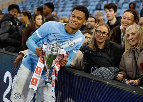 Manchester, England, 14th May 2026. Leke Drake of Manchester City celebrates with the FA Youth Cup trophy with his family following the Manchester City U18 vs Manchester United, ManU U18 FA Youth Cup Final match at the Academy Stadium, Manchester. Picture credit should read: Cody Froggatt Sportimage EDITORIAL USE ONLY. No use with unauthorised audio, video, data, fixture lists, club league logos or live services. Online in-match use limited to 120 images, no video emulation. No use in betting, games or single club league player publications. SPI_092_CF_MANCHESTER_CITY_U18_V_MANCHESTER_UNITED_U18 SPI-4801-0090