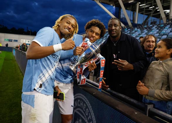 Manchester, England, 14th May 2026. Tyrone Samba (left) and Floyd Samba (right) of Manchester City celebrate with the FA Youth Cup trophy following the Manchester City U18 vs Manchester United, ManU U18 FA Youth Cup Final match at the Academy Stadium, Manchester. Picture credit should read: Cody Froggatt Sportimage EDITORIAL USE ONLY. No use with unauthorised audio, video, data, fixture lists, club league logos or live services. Online in-match use limited to 120 images, no video emulation. No use in betting, games or single club league player publications. SPI_094_CF_MANCHESTER_CITY_U18_V_MANCHESTER_UNITED_U18 SPI-4801-0092