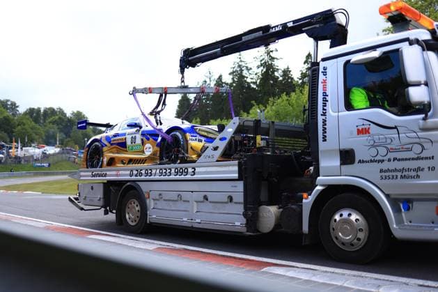 The Mercedes AMG GT3 Fabian Schiller Luca Stolz Maro Engel Maxime Martin Mercedes AMG Team RAVENOL of the Mercedes AMG Team RAVENOL team is transported away on a tow truck from MK Michael Krupp after an incident at the Nürburgring, Müsch The vehicle in the striking blue and gold RAVENOL livery with H R sponsoring is secured on the loading area while the crane arm of the truck holds the car The typical green trees of the Eifel and track elements of the Nürburgring can be seen in the background Mercedes AMG GT3 80 from RAVENOL is transported away on a tow truck Copyright: xMichaelxGelhardtx