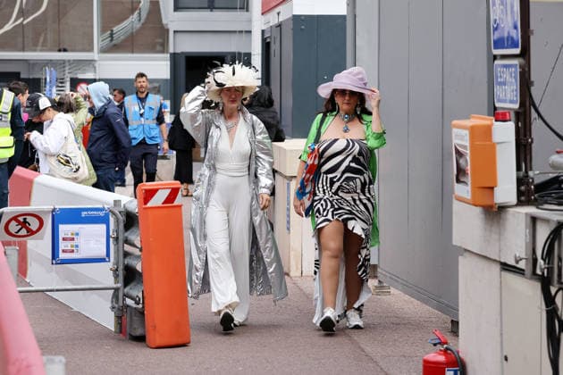 Two women in unusual outfits walk along the pit lane, FIA Formula E World Championship Season 12, Monaco E Prix, MonteCarlo, MC, 15 05 2026,