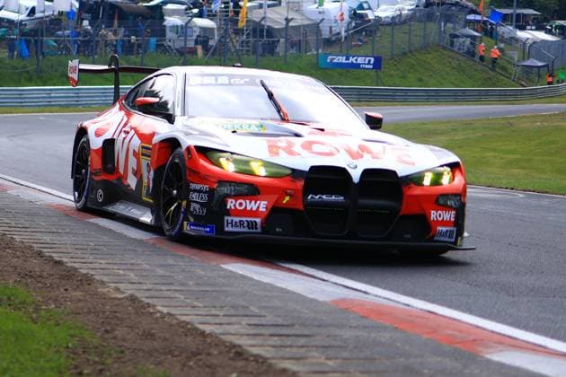 The Augusto Farfus Jordan Pepper Kelvin van der Linde Raffaele Marciello ROWE RACING from ROWE RACING drives through a corner at the Nürburgring The BMW M4 GT3 is presented in the striking red and white ROWE livery with bright yellow and green headlights The sponsors ROWE, H R and Michelin are clearly visible on the bodywork The spectator area and paddock can be seen in the background BMW M4 GT3 1 from ROWE RACING at the Nürburgring Copyright: xMichaelxGelhardtx