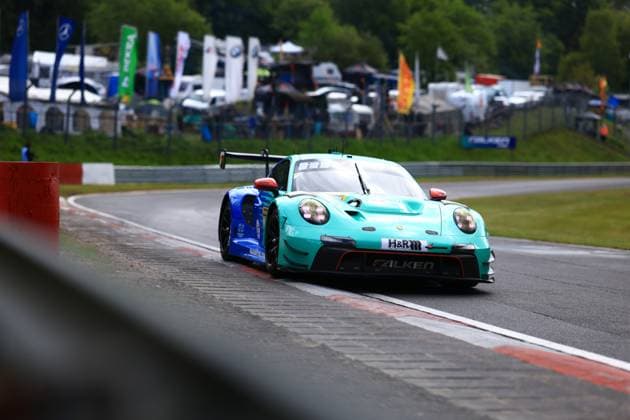 The Klaus Bachler Morris Schuring Sven Müller Tim Heinemann Falken Motorsports from Falken Motorsports takes a corner at the Nürburgring The Porsche 911 GT3 R presents itself in the striking turquoise blue Falken livery with H R and Falken sponsoring The vehicle moves on wet asphalt, flags and the paddock are visible in the background Falken Motorsports Porsche 911 GT3 R 44 at the Nürburgring Copyright: xMichaelxGelhardtx