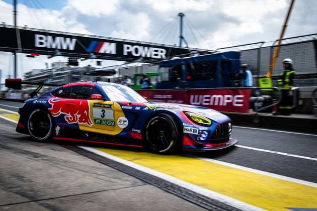 The Mercedes AMG GT3 with starting number 3 of Mercedes AMG Team Verstappen Racing leaves the pit lane at the Nürburgring The car Daniel Juncadella Jules Gounon Lucas Auer Max Verstappen Mercedes AMG Team Verstappen Racing wears the striking Red Bull livery in blue, red and yellow with sponsors such as Viaplay, RAVENOL and H R The BMW M Power banner above the pit lane and the Wempe branding on the pit wall are visible in the background Mercedes AMG GT3 3 from Verstappen Racing in the pit lane at the Nürburgring Copyright: xMichaelxGelhardtx