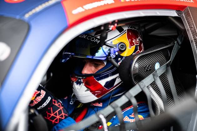 In the cockpit of the Mercedes AMG GT3 from Mercedes AMG Team Verstappen Racing sits a driver wearing a Red Bull helmet and racing overalls The helmet bears the inscription maxverstappen com and the distinctive Red Bull logo The carbon black structures of the interior and the HANS system are visible through the side window of the vehicle The picture was taken at the Nürburgring during the 24-hour race Driver in the cockpit of the Mercedes AMG GT3 3 at the 24h Nürburgring Copyright: xMichaelxGelhardtx