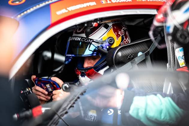 Max Verstappen sits in the cockpit of the Mercedes AMG GT3 from Mercedes AMG Team Verstappen Racing wearing a Red Bull helmet and gazing intently at a control unit in his hands The driver names J Gounon and D Juncadella can be read on the roof of the vehicle The interior shows carbon details, seat belts and the typical GT3 cockpit ambience The scene conveys the intensive preparation before the race at the Nürburgring Max Verstappen in the cockpit of the Mercedes AMG GT3 3 at the Nürburgring Copyright: xMichaelxGelhardtx