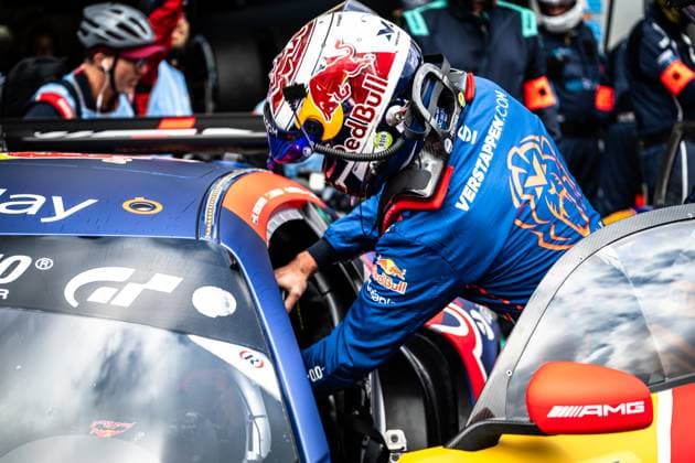 A driver in a Red Bull helmet and blue Verstappen com racing overall gets into the Mercedes AMG GT3 of the Mercedes AMG Team Verstappen Racing The scene shows a driver change in the pits at the 24-hour race at the Nürburgring The sponsors Gran Turismo GT and Red Bull are clearly visible on the vehicle The AMG logo on the door mirror is clearly recognizable Racing vehicle Driver change on the Mercedes AMG GT3 from Verstappen Racing at the Nürburgring Copyright: xMichaelxGelhardtx