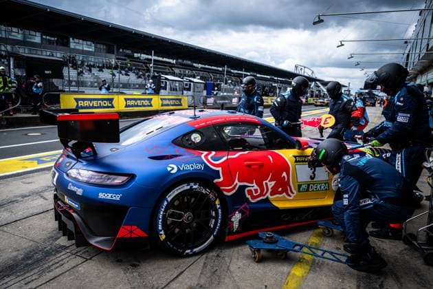 The Mercedes AMG GT3 with the starting number 3 of the Mercedes AMG Team Verstappen Racing is parked in the pit lane at the Nürburgring during a pit stop The mechanics in dark blue team uniforms are concentrating on the car, which is painted in the striking Red Bull design in blue, red and yellow Sponsors such as Viaplay, Sparco and RAVENOL are clearly visible on the car In the background, the pit wall with RAVENOL advertising banners and the main grandstand of the Nürburgring can be seen Daniel Juncadella Jules Gounon Lucas Auer Max Verstappen Mercedes AMG Team Verstappen Racing Mercedes AMG GT3 3 from Verstappen Racing at the pit stop at the Nürburgring Copyright: xMichaelxGelhardtx