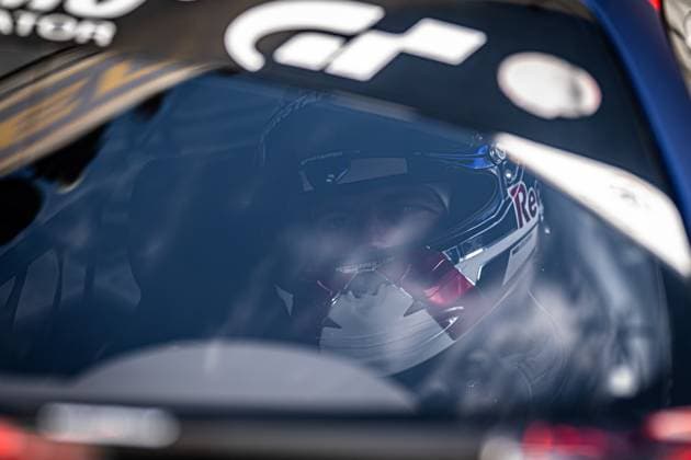 A driver with a white helmet can be seen through the side window of a racing car, on which the lettering verstappen com and the Red Bull logo are clearly visible The GT logo on the vehicle roof and the blue paint of the car refer to the Mercedes AMG Team Verstappen Racing at the ADAC RAVENOL 24h Nürburgring 2026 Max Verstappen in the cockpit at the 24h Nürburgring 2026 Copyright: xMichaelxGelhardtx