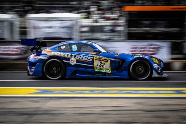 The Andreas Gülden Tim Sandtler Yuichi Nakayama Toyo Tires with Ring Racing from Toyo Tires with Ring Racing drives through the pit lane at the Nürburgring at high speed The blue and gold Mercedes AMG GT3 prominently bears the Toyo Tires and RAVENOL logos as well as the starting number 32 The vehicle is captured with motion blur in the background in a dynamic panning shot Mercedes AMG GT3 32 from Toyo Tires with Ring Racing in the pit lane Copyright: xMichaelxGelhardtx