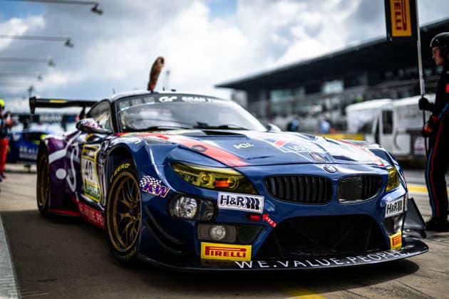 The BMW Z4 GT3 with starting number 40 of the W I S Racing Team powered by Koopman Racing team is parked in the pit lane at the Nürburgring The dark blue vehicle Frank Nikolaus Michael Funke Peter Posavac W I S Racing Team powered by Koopman Racing bears sponsor logos from H R, KW and Pirelli and is fitted with gold rims The main grandstands of the Nürburgring as well as other vehicles and team members can be seen in the background BMW Z4 GT3 40 from W I S Racing in the pit lane at the Nürburgring Copyright: xMichaelxGelhardtx