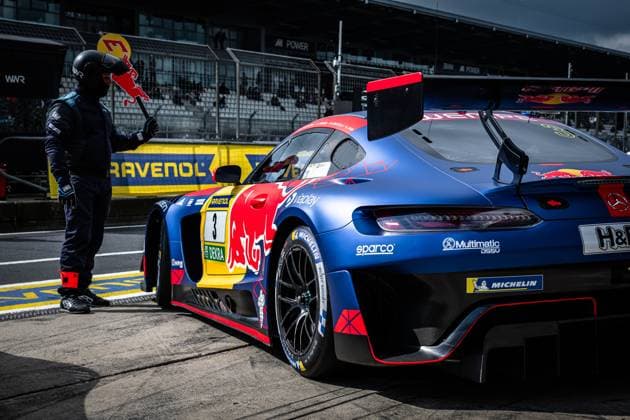 The Mercedes AMG GT3 with starting number 3 of the Mercedes AMG Team Verstappen Racing is parked in the pit lane at the Nürburgring The car wears the characteristic Red Bull livery in blue, red and yellow and features sponsors such as RAVENOL, DEKRA, Michelin, Sparco and Multimatic DSSV A crew member holds a Red Bull sign next to the car, while the pit area and grandstands with spectators can be seen in the background Daniel Juncadella Jules Gounon Lucas Auer Max Verstappen Mercedes AMG Team Verstappen Racing Mercedes AMG GT3 3 from Verstappen Racing in the pit lane Copyright: xMichaelxGelhardtx