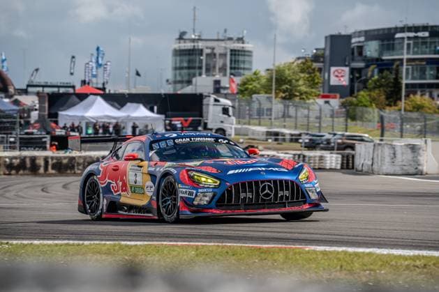 The Mercedes AMG GT3 with the starting number 3 of the Mercedes AMG Team Verstappen Racing drives through the pit lane or the track area at the Nürburgring The vehicle Daniel Juncadella Jules Gounon Lucas Auer Max Verstappen Mercedes AMG Team Verstappen Racing wears a striking blue and red Red Bull livery with Spider Man motif and is decorated with sponsors such as Gran Turismo, Viaplay, H R and Sparco The characteristic buildings of the Nürburgring and the AMG logo are visible in the background Mercedes AMG GT3 3 from Verstappen Racing at the Nürburgring Copyright: xMichaelxSchäferx