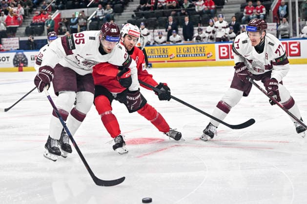 ZURICH, SWITZERLAND MAY 16 Oskars Batna of Latvia L and Kristaps Zile of Latvia R in a battle for the puck with Nico Hischier of Switzerland during the 2026 IIHF Ice Hockey World Championship Switzerland game between Switzerland and Latvia at Swiss Life Arena on May 16, 2026 in Zurich, Zurich Zurich Swiss Life Arena Zurich Switzerland Switzerland Copyright: xJustPictures.ch AndreaxBrancax jp-en-EuSpIm-JP7_ANB_Sui_Lat_16052026_3585