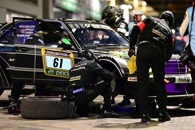 Bruno Spengler Christian Gebhardt Evald Holstad Peter Ludwig HWA Engineering Speed from HWA Engineering Speed completes a pit stop at the Nürburgring during the night Mechanics in black overalls with HWA and Kärcher logos work intently on the vehicle One kneels at the front wheel and changes the tire, A worn tire is already lying on the pit asphalt Another mechanic cleans the front of the car with a yellow cloth The drivers names Adelson, Arnold, Green and Van der Zande are listed on the drivers door Sponsors such as RAVENOL, Sparco, Parkside and Kärcher are clearly visible Night pit stop 61 by HWA Engineering Speed at the Nürburgring Copyright: xMichaelxGelhardtx
