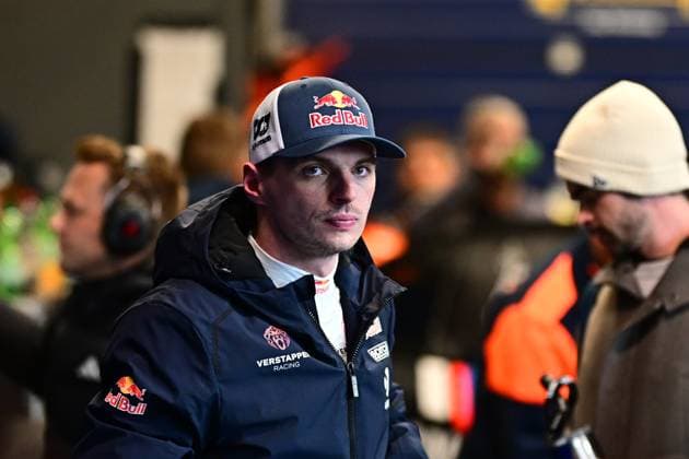 Max Verstappen can be seen in the paddock at the Nürburgring He is wearing a dark blue jacket with the Verstappen Racing logo and a Red Bull cap Other people and the hustle and bustle in the paddock can be seen in the background Max Verstappen in the paddock at the 24h Nürburgring 2026 Copyright: xMichaelxGelhardtx